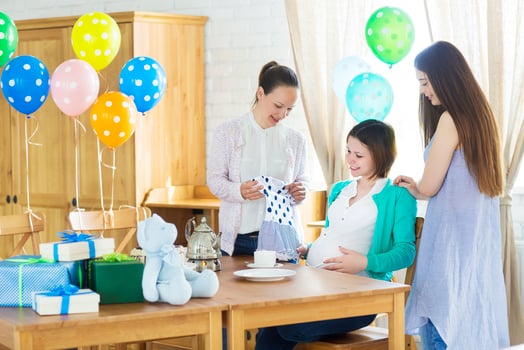 Pregnant woman with friends at a baby shower photo