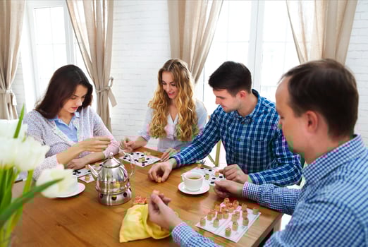 Happy young friends playing board game together photo