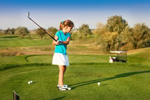 Cute little girl playing golf on a field outdoor photo