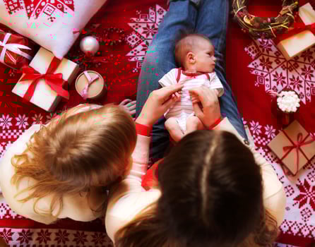 Mother and little children having fun in Christmas time. Top view photo