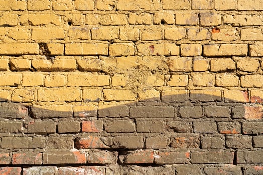 Brick wall painted yellow. Background texture. photo