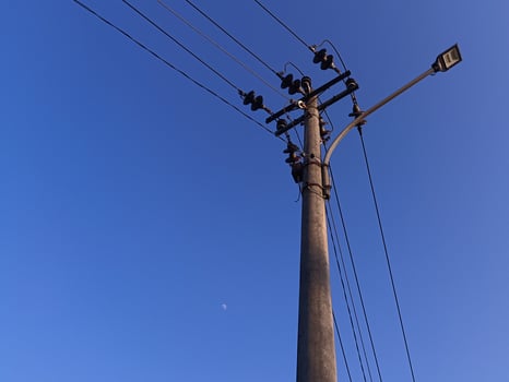 Power electric pole with line wire for residential buildings with blue sky background photo