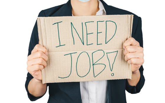 Cropped shot of young business woman holding a sign paper for seeking a job. Many people laid off from work because impact from covid-19 pandemic outbreak. photo