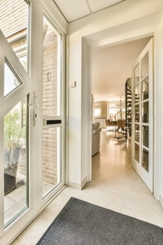 A white door with a black mat on the floor photo