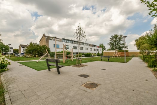 A playground area with a swing set and benches photo