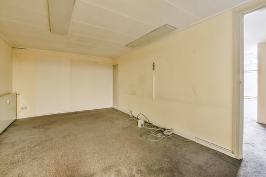 An empty room with a door and a window photo