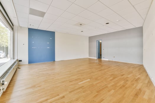 An empty room with wooden floors and blue walls photo