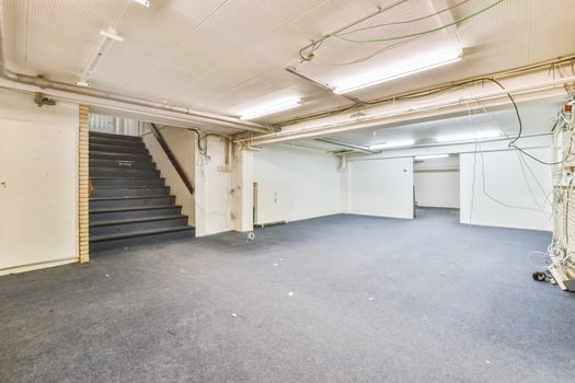 An empty room with stairs and a ceiling fan photo
