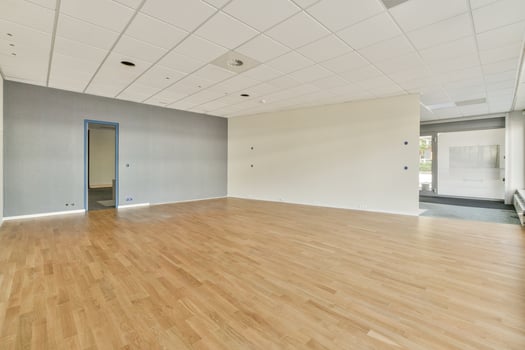 An empty room with wooden floors and white walls photo