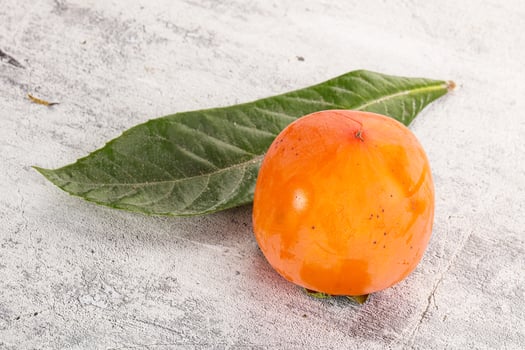 Fresh ripe sweet juicy persimmon photo