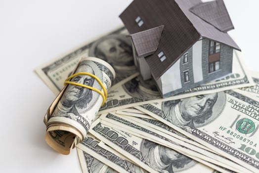 Money dollar and The model of a wooden house. Concept Having a house or buying a home or home loan. photo