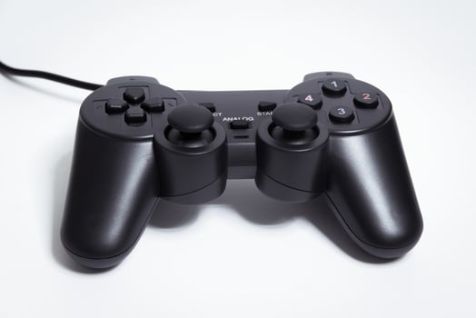 Black controller on white background, game device, Joystick on a white background. photo