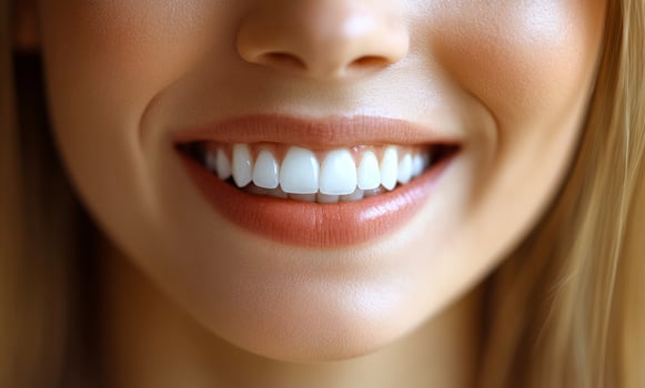 A woman with a big smile on her face, showing off her teeth. Concept of happiness and confidence photo