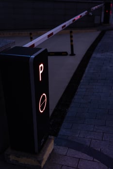 Parking post with a barrier at the entrance to the business center late at night photo