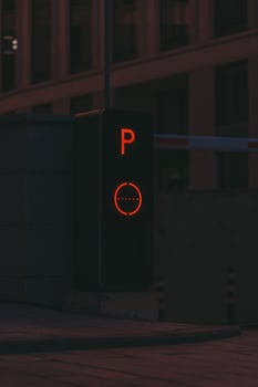 Parking post with a barrier at the entrance to the business center late at night photo