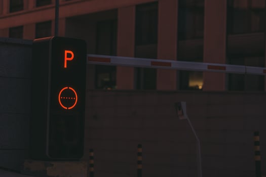 Parking post with a barrier at the entrance to the business center late at night photo