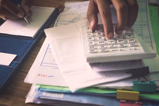 Hands of a man calculating his expenditure. photo