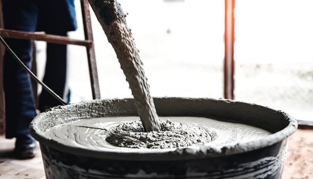 Concrete being poured into a bucket photo