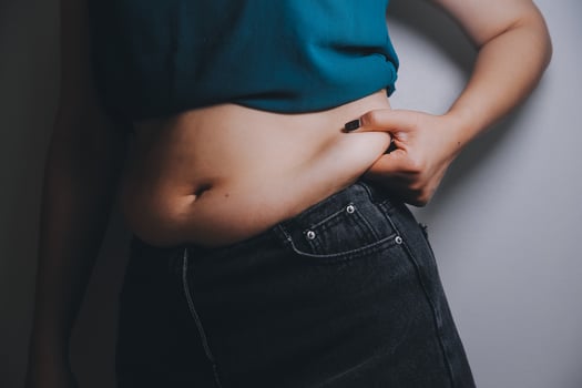 fat woman, fat belly, chubby, obese woman hand holding excessive belly fat with measure tape, woman diet lifestyle concept photo