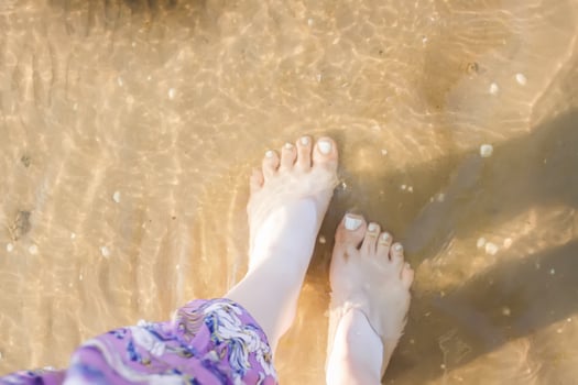 Woman's bare feet walking at a beach. photo