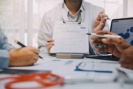 Meeting, tablet and team of doctors with collaboration for healthcare talk and telehealth app in office. Surgeon group, tech and medical discussion with website for hospital funding or sponsorship photo