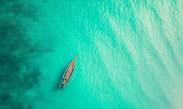 Boat on the water surface from top view, turquoise blue water background from top view, summer seascape from air, island, travel and vacation image photo