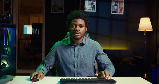 African american player shouting after failing to win videogame while playing on gaming PC. Upset gamer at computer desktop in apartment feeling like smashing desk, raging after game over photo