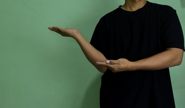 Young man pointing at copy space, showing and advertising empty space photo