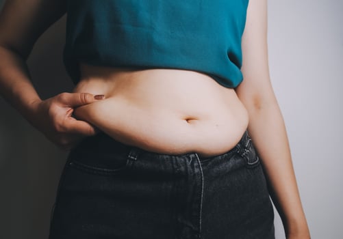 fat woman, fat belly, chubby, obese woman hand holding excessive belly fat with measure tape, woman diet lifestyle concept photo