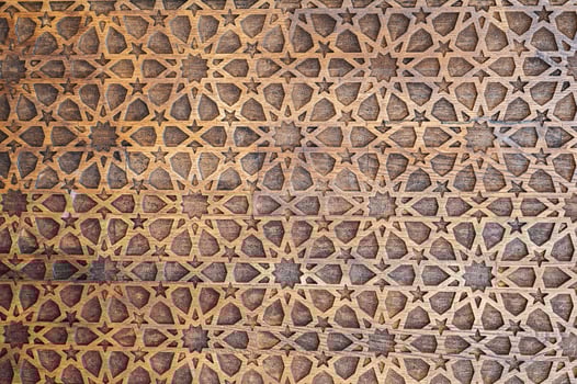 Uzbek Islamic patterns ornament with stars on a modern wooden carved door in Uzbekistan close up photo
