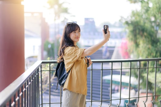 Traveler young asian woman in her 30s navigates Bangkok with her camera. Capture the world with confidence and share your unique story. photo