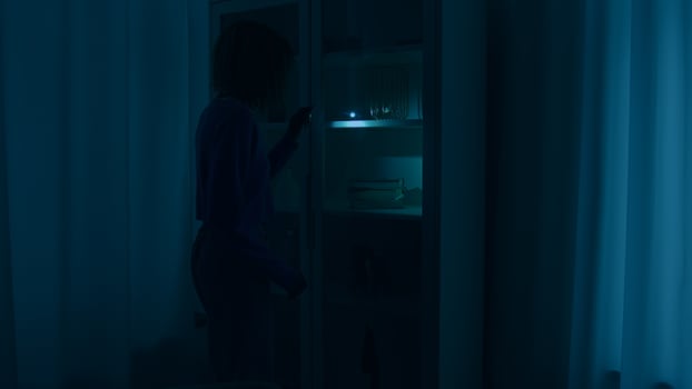Confused unrecognizable woman girl walking in dark room night war blackout trouble search with light check closet electricity energy crisis outage searching lost with flashlight at home darkness crime photo