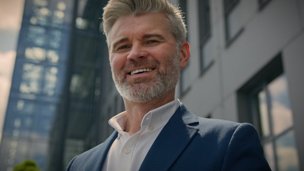 Middle-aged man senior mature business employer businessman browsing mobile phone chatting app smartphone check email network media scrolling cellphone in city near office building smiling at camera photo