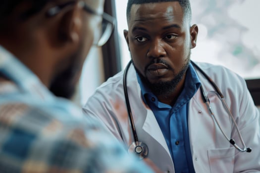 A Close Up of an African American Doctor Talking to a Patient photo