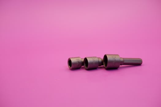 Hexagon screwdriver bit sockets measuring 7 mm, 8 mm, and 10 mm isolated on purple background. photo