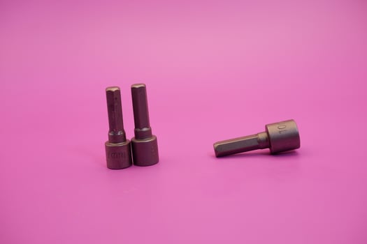 Hexagon screwdriver bit sockets measuring 7 mm, 8 mm, and 10 mm isolated on purple background. photo