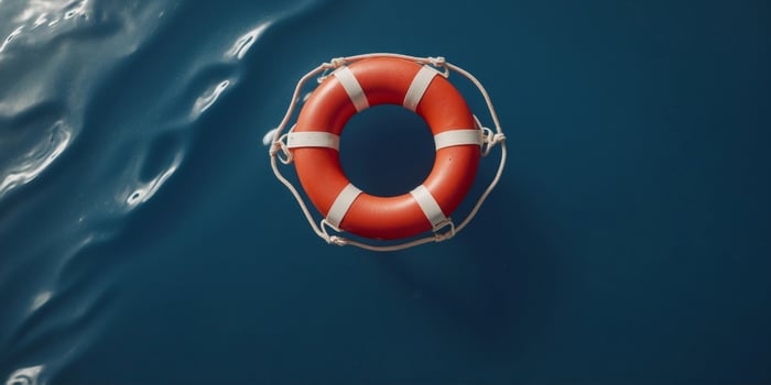 Top view of lifebuoy floating on top blue water. photo