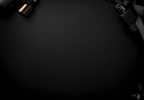 A black background with a faint shine and the hint of luxury products in the corners, perfect for adding advertising text photo