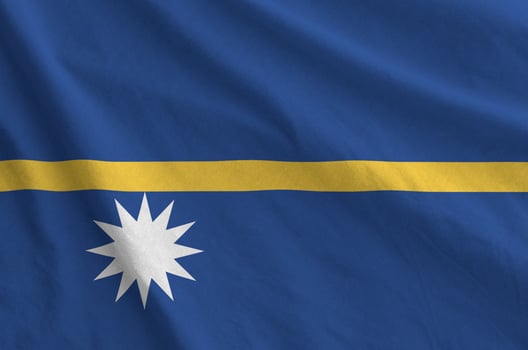 Nauru flag depicted on folded wavy fabric of old cloth photo