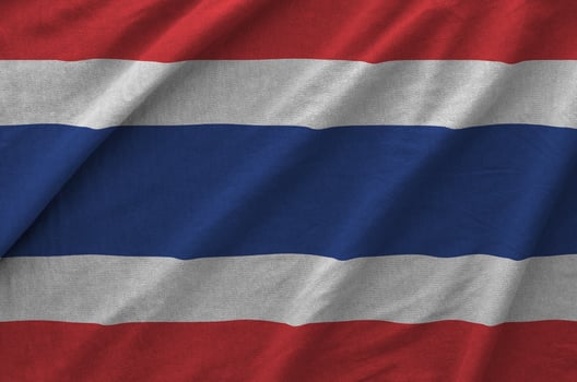 Thailand flag depicted on folded wavy fabric of old cloth photo