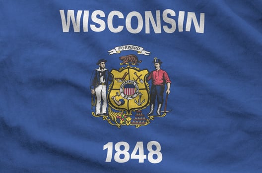 Wisconsin US state flag depicted on folded wavy fabric of old cloth photo