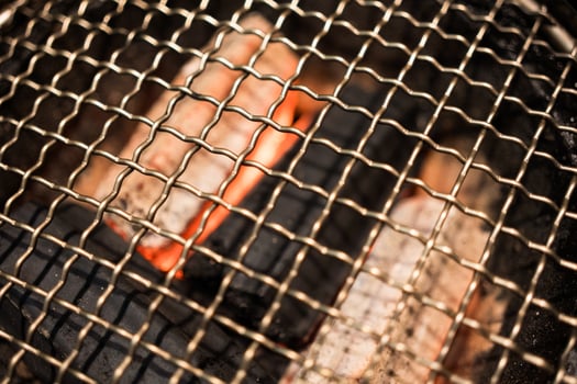 Close up of grille with hot charcoal grill stove photo