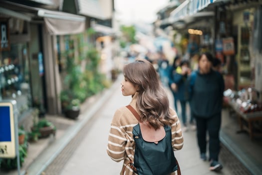 Woman tourist Visiting in Enoshima Island, Fujisawa, Kanagawa, Japan. happy Traveler sightseeing Enoshima Shrine. Landmark and popular for tourists attraction near Tokyo. Travel and Vacation concept photo