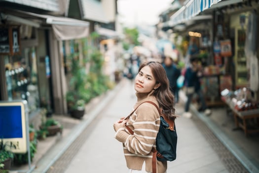 Woman tourist Visiting in Enoshima Island, Fujisawa, Kanagawa, Japan. happy Traveler sightseeing Enoshima Shrine. Landmark and popular for tourists attraction near Tokyo. Travel and Vacation concept photo