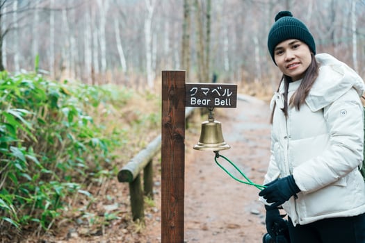 Woman tourist travel Kamikochi National Park, happy Traveler with Bear bell in the forest, Nagano Prefecture, Japan. Landmark for tourists attraction. Japan Travel, Destination and Vacation photo