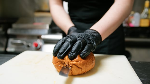 Knife Cutting Of A Bread Bun To Start Dish Preparation photo