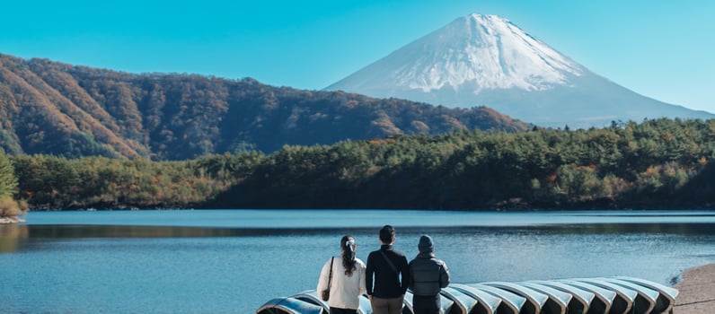tourists enjoy with Fuji Mountain at Lake Saiko, happy friends group travel Mount Fuji and road trip Fuji Five Lakes. Landmark for tourists attraction. Japan Travel, Destination and Vacation concept photo