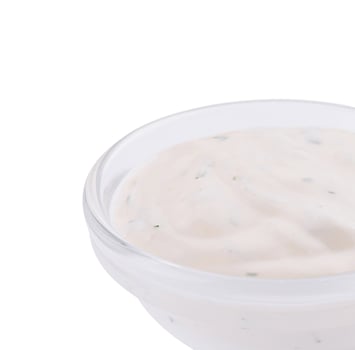 Creamy ranch dressing in clear bowl isolated on white photo