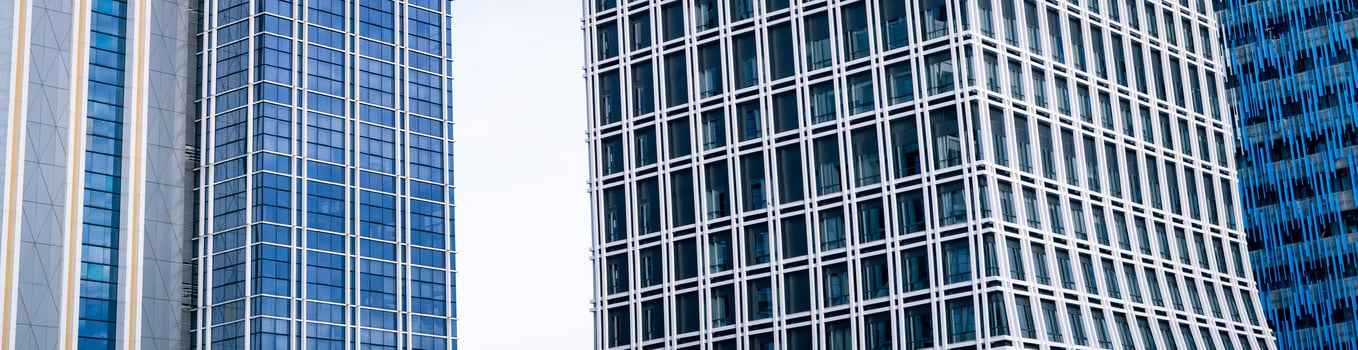Skyscraper glass building of corporate headquarters in the downtown business area. Towering facade and windows embodying sleek, modern office environment. Financial institution. Modern architecture. photo