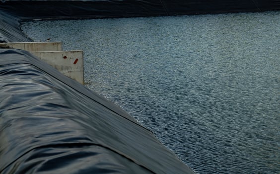 Aquaculture farming pond liner system. HDPE geomembrane technology. Water containment and environmental protection in sustainable fish farming. High-density polyethylene transforms aquaculture ponds. photo